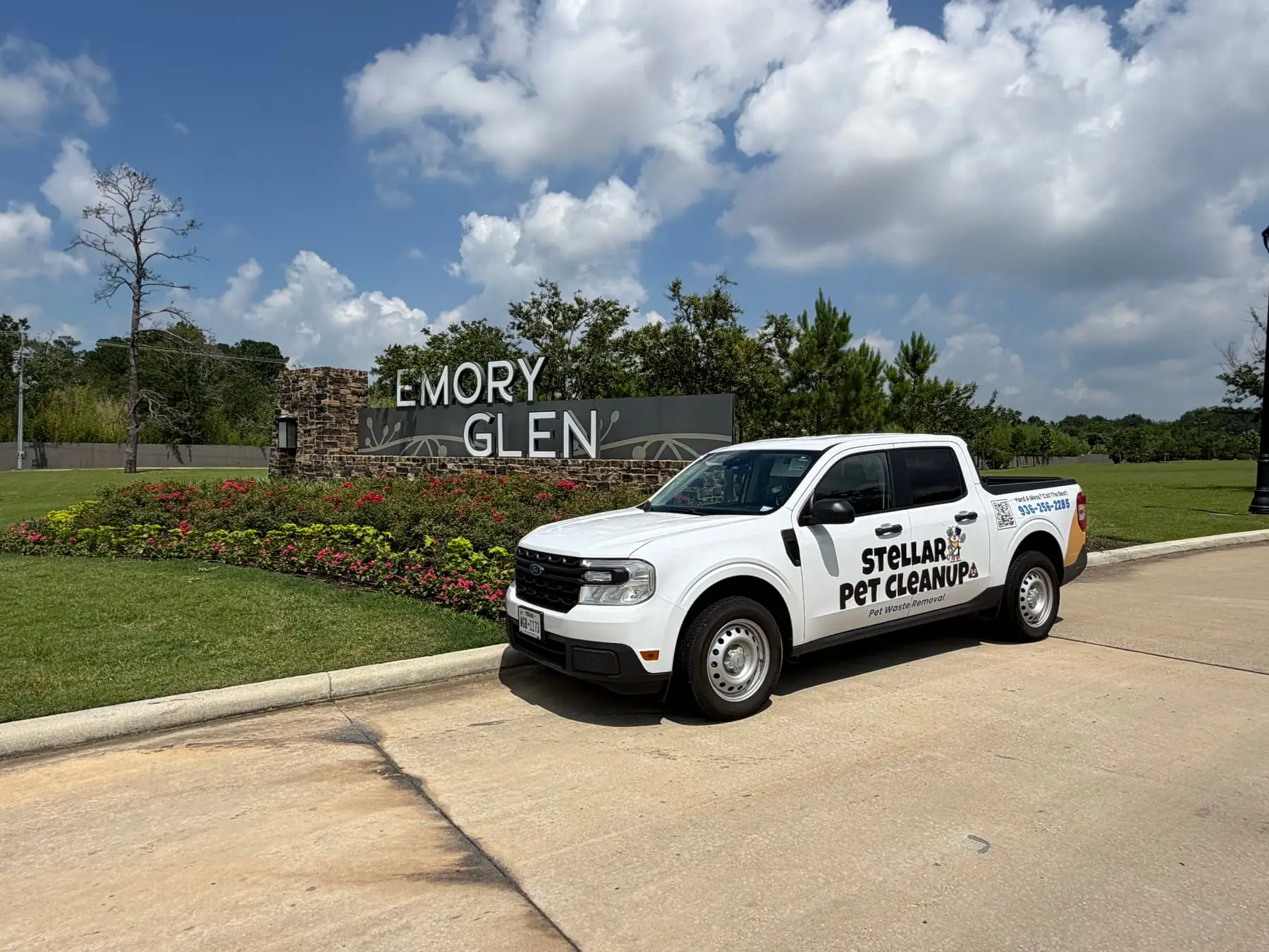 Stellar Pet Cleanup's wrapped white pickup parked at the Emory Glen community entrance in Montgomery County, TX